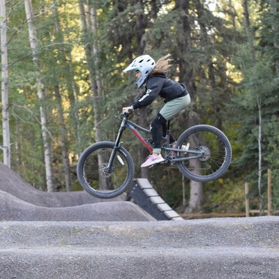 Biker jumping their bike at a bike park