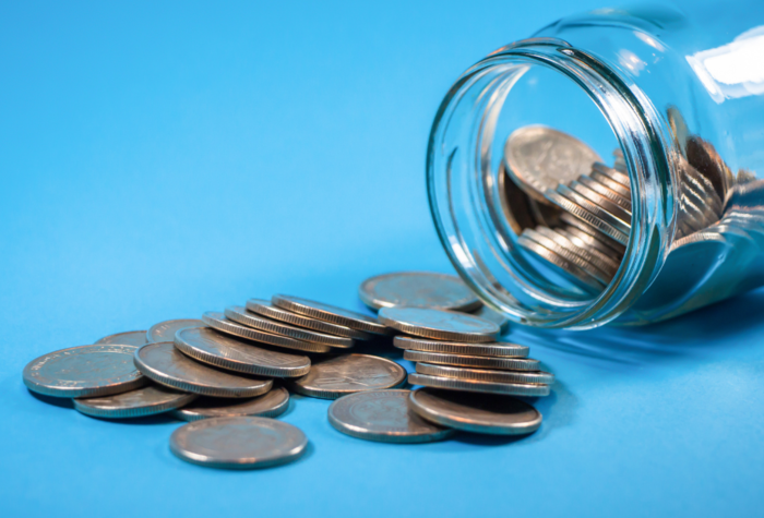 coins spilling out of a tipped over jar