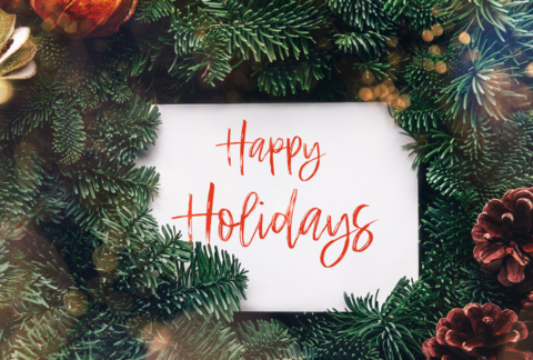 Happy holiday text, card concept. Holiday background with whitecard in the middle of evergreen tree branches, christmas and festice season idea