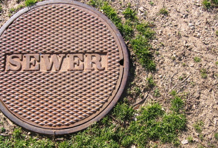 an image of a rusty sewer lid